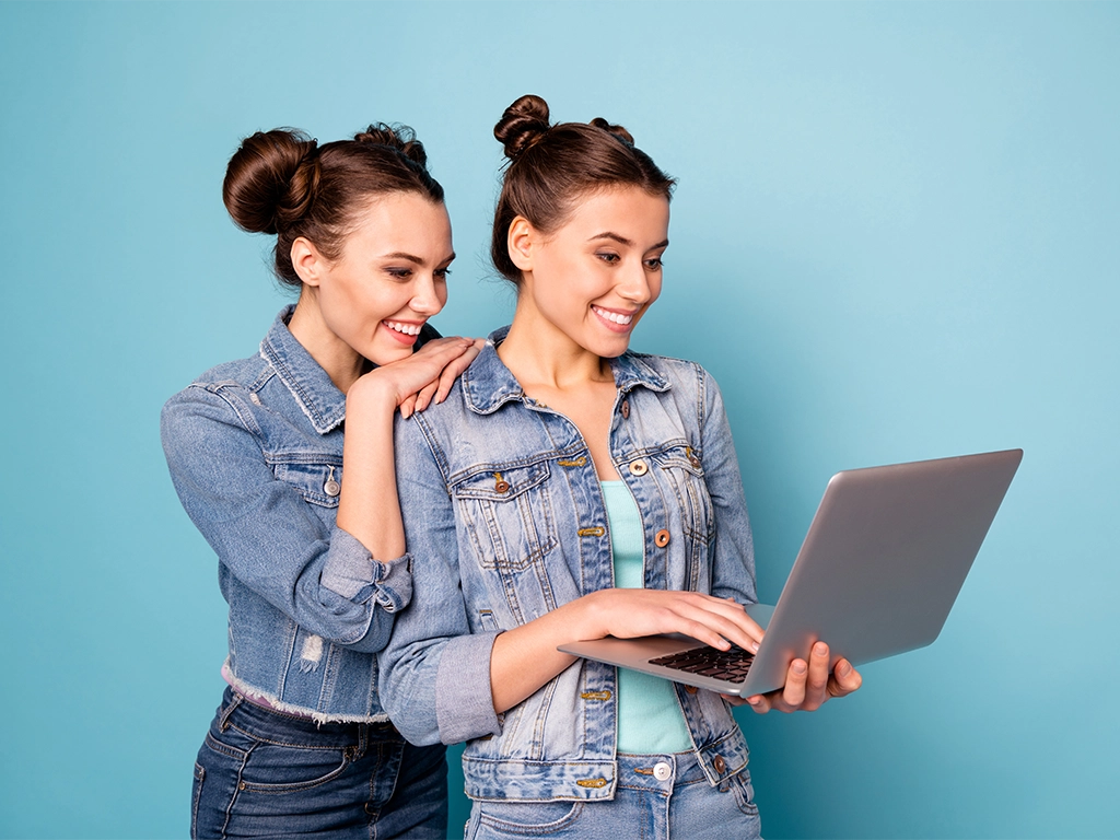 Two smiling young women reviewing Northbrook Family Dental patient stories