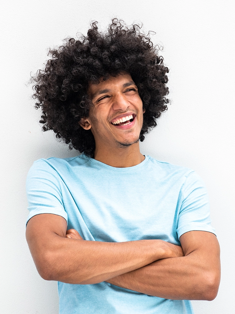 Laughing young man with healthy smile reflecting oral health's link to wellness