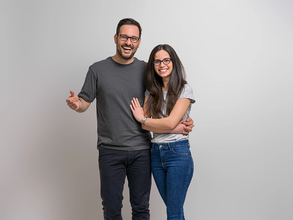 Laughing couple with healthy smiles after wisdom teeth extraction recovery